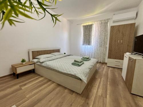 a bedroom with a bed and a television in it at KA Home in Petrich