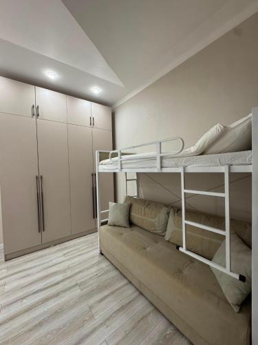 a living room with a bunk bed and a couch at Cottage in Bosteri