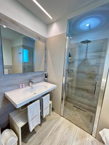 a bathroom with a sink and a shower at Hotel Eden in Bibione