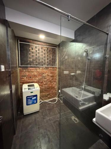 a bathroom with a glass shower and a sink at Eldorado Apartments F2P3 Wattala in Alwis Town