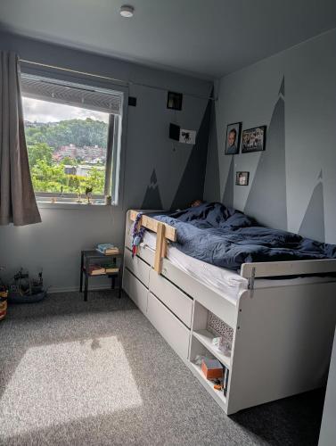 a bedroom with a bed and a window at Kongleveien 11C in Sandnes
