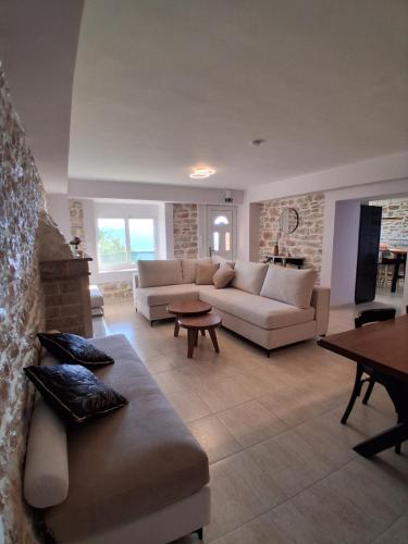 a living room with a couch and a table at Οcalia Apartment in Petrokhórion