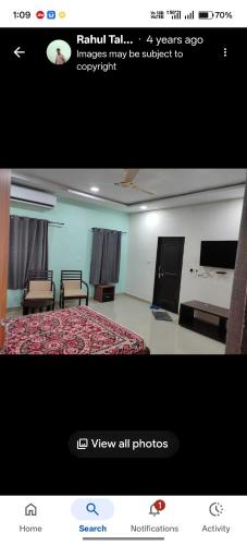 a room with a bed and two chairs in a room at Rail connect hotel statue of unity in Kevadia