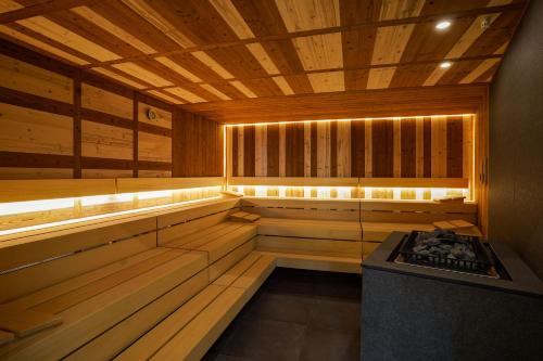 a large wooden sauna with a stove in it at Degenija Boutique hotel & Spa in Seliste Dreznicko
