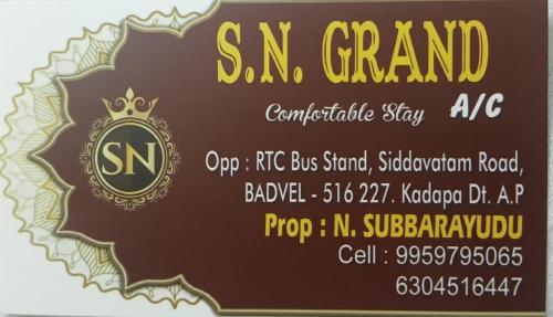 a sign for a snm grand car dealership at SN Grand lodge AC in Badvel
