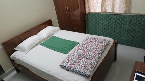 a bed with two pillows and a blanket on it at SN Grand lodge AC in Badvel