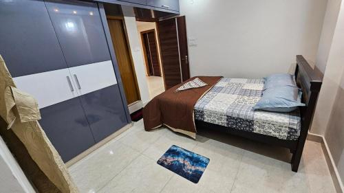 a small bedroom with a bed and a large cabinet at Hill View Haven in Rushikonda