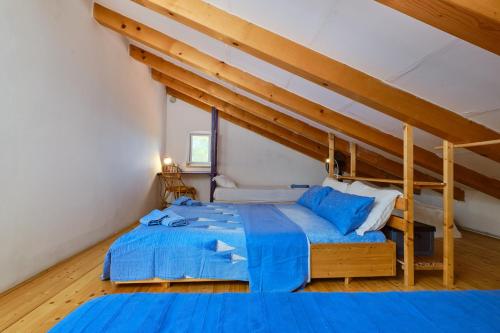 a bedroom with a large blue bed in a room at Lošinj house Robinzon Studenčić Island Lošinj in Čunski