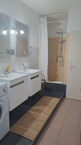 a white bathroom with a sink and a shower at Apartment Feral in Neum