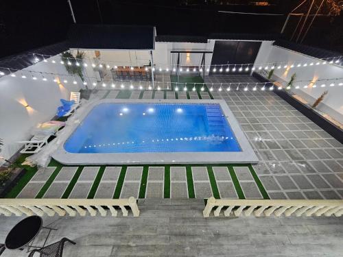 a swimming pool with lights on top of a building at Dreamvilla aframe in Gabala