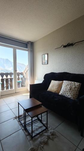 a living room with a couch and a coffee table at Laura Studio - Pla d'Adet Pied des pistes - balcon Vue vallée - ménage inclus dès 5 nuits in Saint-Lary-Soulan