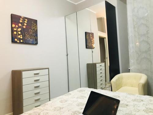 a bedroom with a bed with a laptop on it at CASA Di ANNA 2 in Terracina