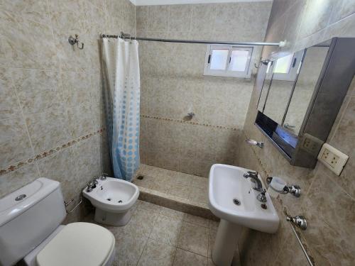 a bathroom with a toilet and a sink and a shower at Chalet ARMONIA in La Falda