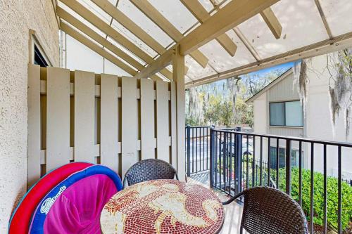 a patio with chairs and a fence and a fence at Springwood Villas 51 in Hilton Head Island