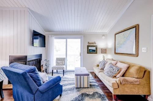 a living room with a couch and two chairs at Driftwood Villa - 269 in Edisto Island