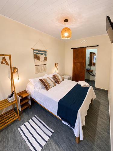 a bedroom with a large bed in a room at Pousada Narval Buzios in Búzios