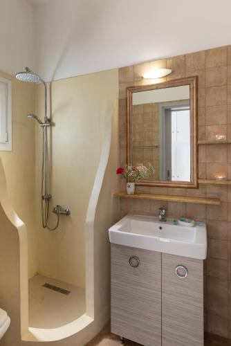 a bathroom with a sink and a shower at Syros Private House with superb sea view in Kini