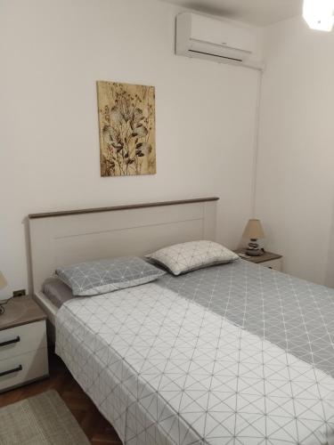 a bedroom with a bed and a picture on the wall at Apartments Smolica in Labin