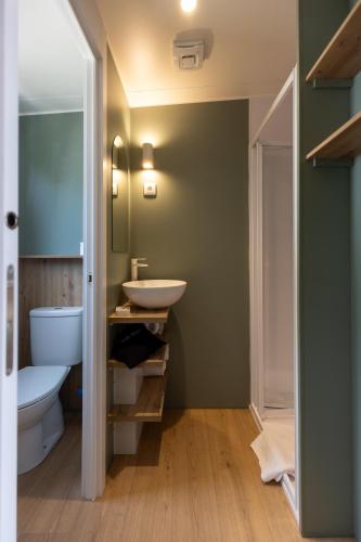 a bathroom with a sink and a toilet at Camping As Cancelas in Santiago de Compostela