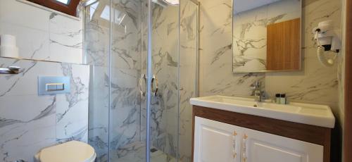 a bathroom with a shower and a sink at Grand Peninsula Hotel in Istanbul