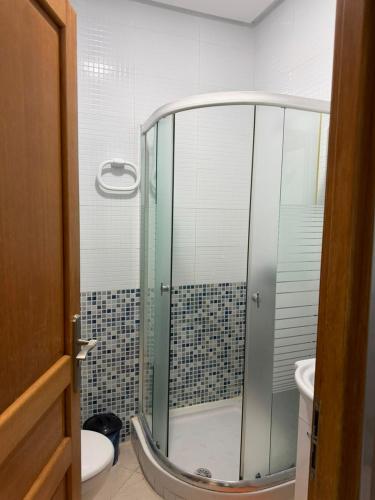 a bathroom with a glass shower with a toilet at Peaceful Home in Cabo Negro