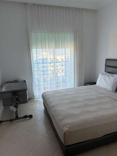 a bedroom with a large bed and a large window at Peaceful Home in Cabo Negro