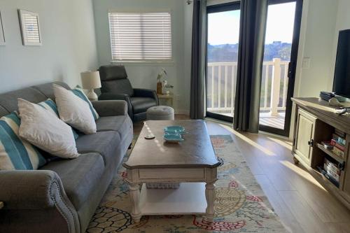 a living room with a couch and a coffee table at Bay Creek Villa - 304 in Edisto Island