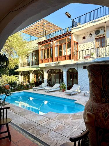 a large house with a swimming pool in front of it at Hostal Andino - Adults Only in Cafayate