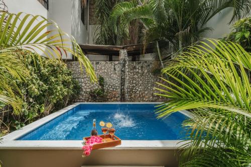 a small swimming pool with a toy boat in it at Casa Aura Hotel, Mérida in Mérida