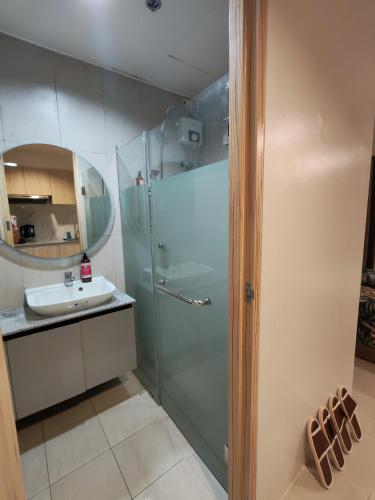 a bathroom with a shower and a sink at inspiria condo davao 14th in Davao City