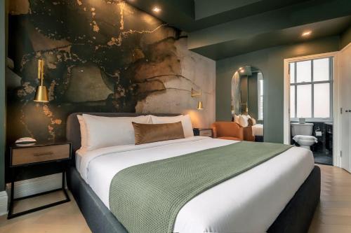 a bedroom with a large bed and a bathroom at NoMad Studio Near Broadway & Madison Square in New York