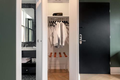 a bathroom with a black door and a sink at NoMad Studio Near Broadway & Madison Square in New York