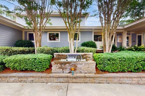 a home with a fountain in front of a house at Fiddlers Cove 6J in Hilton Head Island