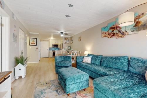 a living room with a blue couch and chairs at Fiddlers Cove 6J in Hilton Head Island