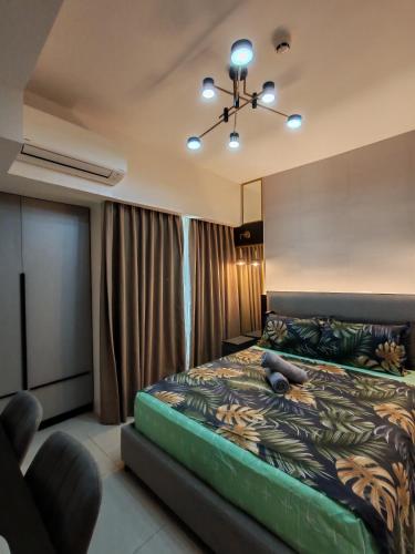 a bedroom with a bed and a chair in it at inspiria condo davao 14th in Davao City