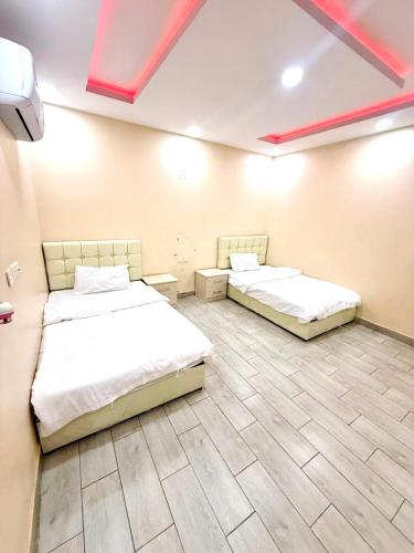 two beds sitting in a room with a room with at شاليهات زارا 2 in Taif