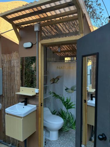a bathroom with a toilet and a pergola at Glamping Ramas De Elqui in Pisco Elqui