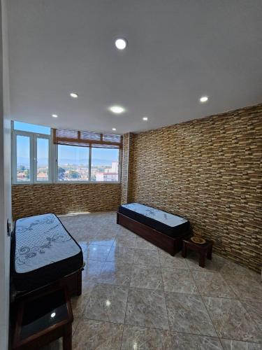 a room with two beds and a large window at Appartement Birkhadem in Birkhadem