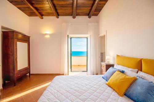 a bedroom with a bed with a view of the ocean at Villa Belvedere Amodeo - terrace, seaview, wifi in Conca dei Marini