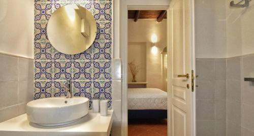 a bathroom with a sink and a mirror on the wall at Villa Belvedere Amodeo - terrace, seaview, wifi in Conca dei Marini