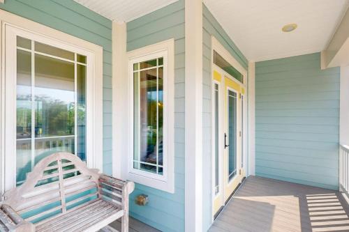 a bench sitting on the front porch of a house at Sweet Carolina in Edisto Island