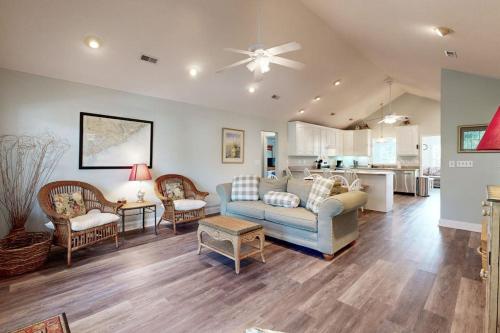 a living room with a couch and a kitchen at Pompano End in Edisto Island