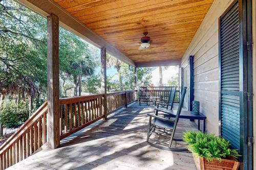 a porch with a rocking chair on a house at Natural Wonder in Edisto Island