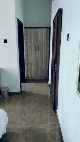 a hallway with two doors and a room with a hallwayngthngthngthngthngth at Meglams Hotel and Suite in Yenagoa