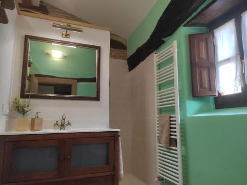 a bathroom with a sink and a mirror at Etxezarra in Sáseta