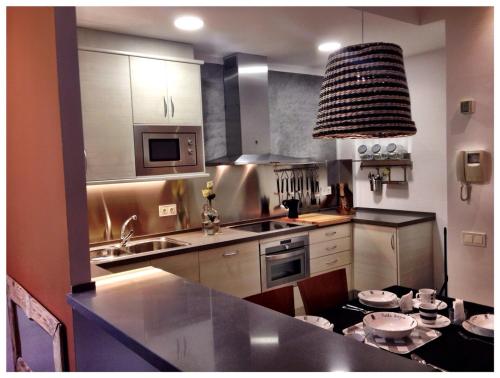 a kitchen with a sink and a counter top at Casas Apartamentos Gracia in Barcelona