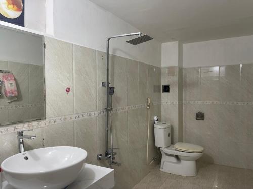 a bathroom with a sink and a toilet and a shower at David Home in Danang