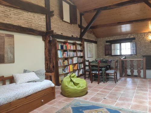 a living room with a bed and a book shelf at Etxezarra in Sáseta