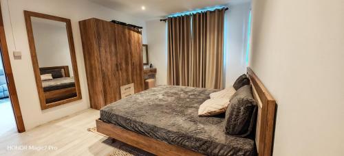 a bedroom with a bed and a mirror at RM Westside Apartment in Case Noyale