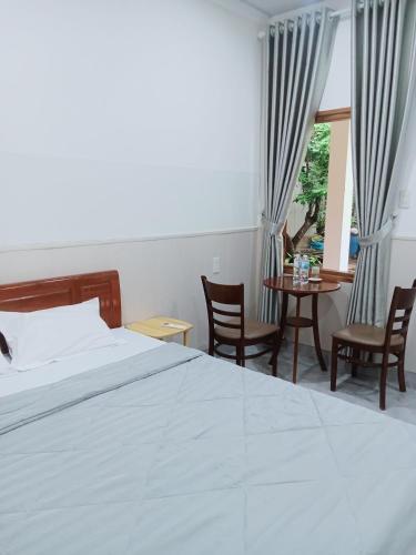 a bedroom with a bed and a table and chairs at Hue garden homestay in Thôn Trường Giang